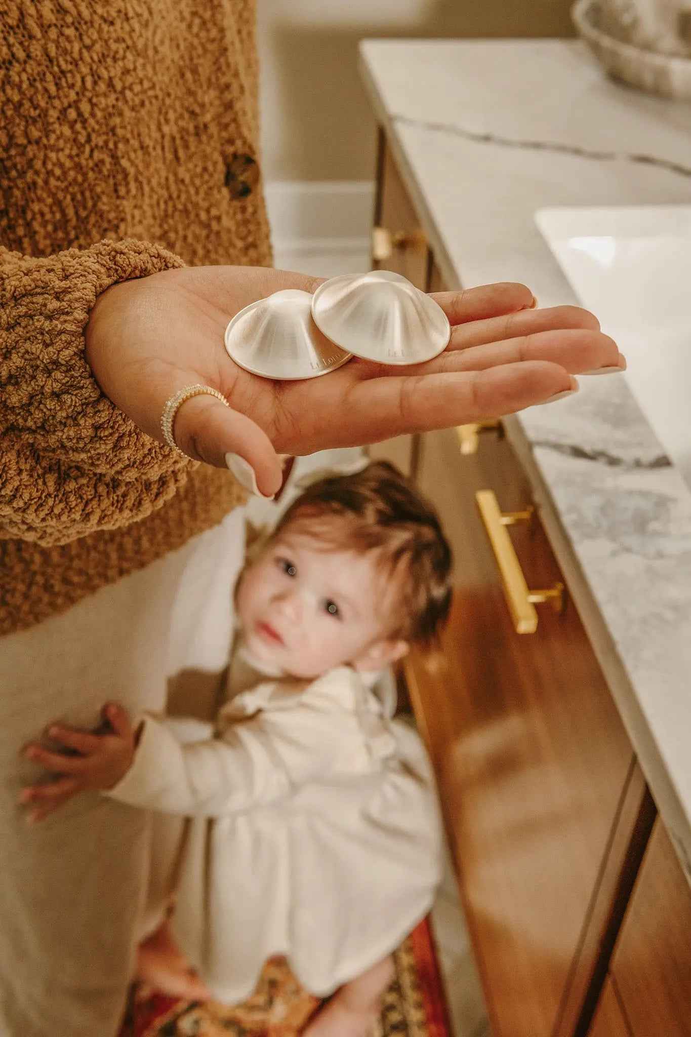 Le Lolo 999 silver nursing cups with intricate engraved designs, showcasing traditional craftsmanship and detailed silverwork.