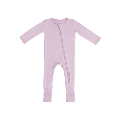 Baby wearing Dreamland Baby bamboo pajamas with DreamCuffs®, featuring soft fabric and snug fit for comfort and sleep.