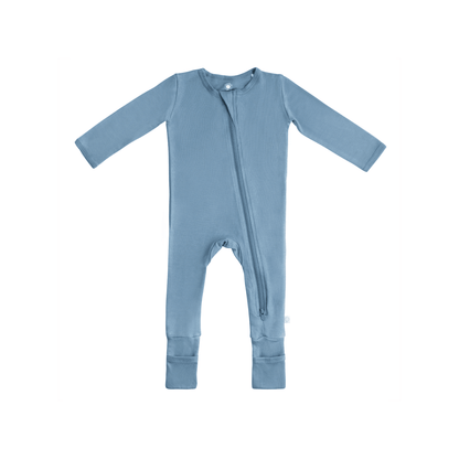 Baby in soft bamboo pajamas with DreamCuffs® from Dreamland Baby, featuring comfortable fabric and secure sleep features.