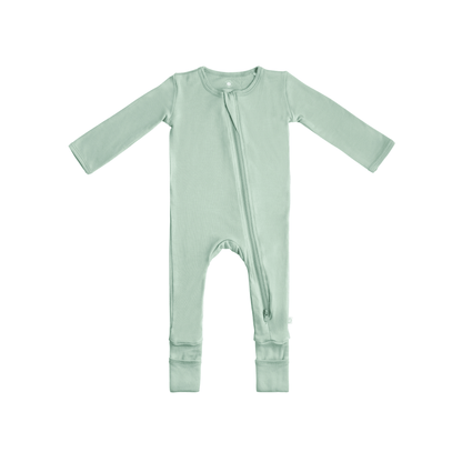 Baby wearing Dreamland Baby Bamboo Pajamas with DreamCuffs®, soft fabric, and cozy design for comfortable sleep.