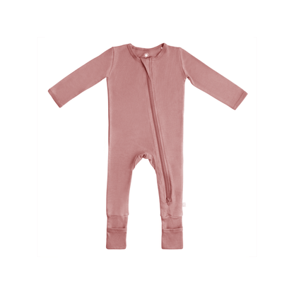 Baby wearing Dreamland Baby bamboo pajamas with DreamCuffs®, featuring soft fabric and snug fit for comfortable sleep.