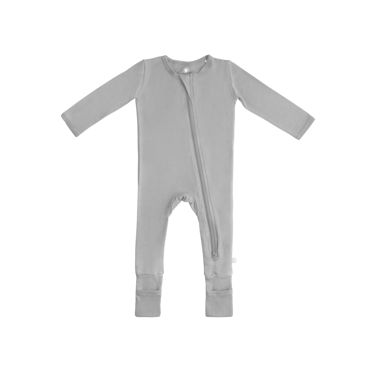 Baby in soft bamboo pajamas with DreamCuffs® from Dreamland Baby, featuring snug fit and cozy comfort for restful sleep.