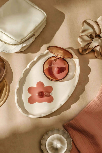Le Lolo colored nipple shield system showing vibrant, soft silicone shields with adjustable straps for sensitive skin protection.