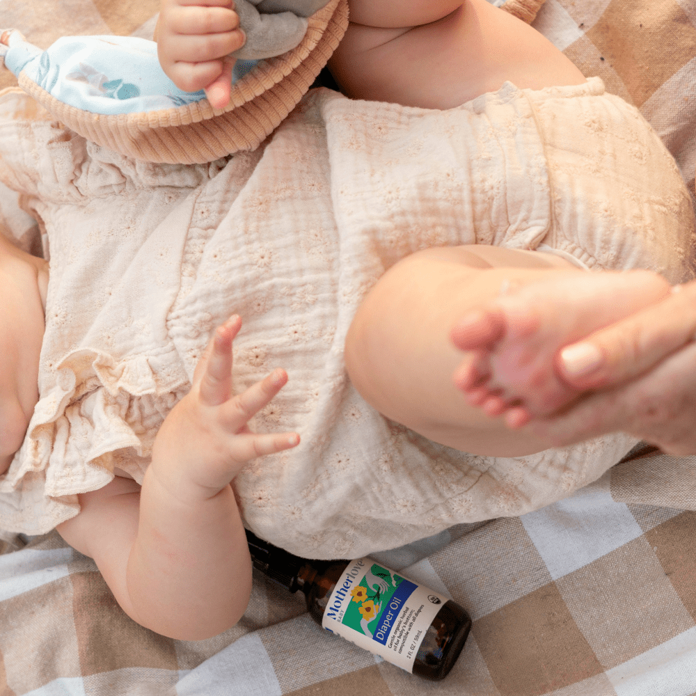 Baby diaper oil from Motherlove Herbal Company with natural ingredients, designed to soothe and protect your baby's delicate skin.
