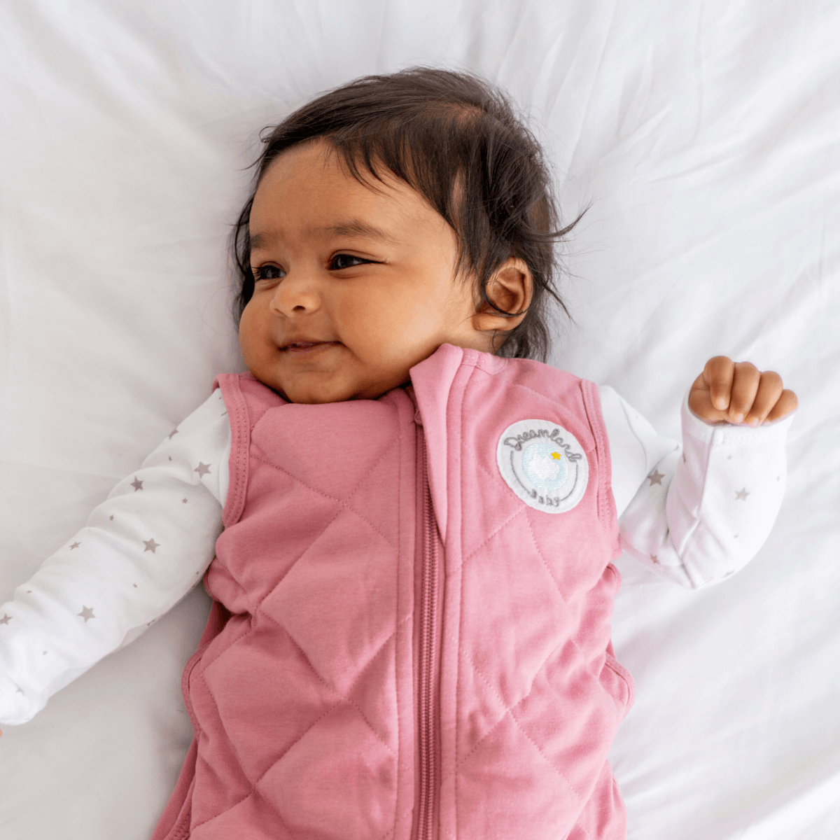Dreamland Baby Dream Weighted Sleep Sack lying flat, showing soft fabric and secure shoulder snaps for safe sleep comfort.