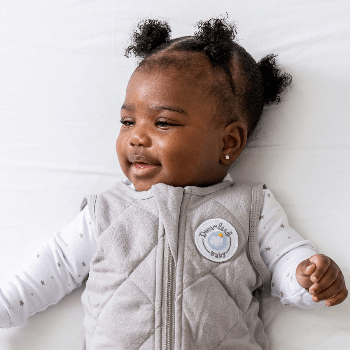 Dreamland Baby Dream Weighted Sleep Sack lying flat, soft fabric, with adjustable straps for safe, cozy sleep comfort.