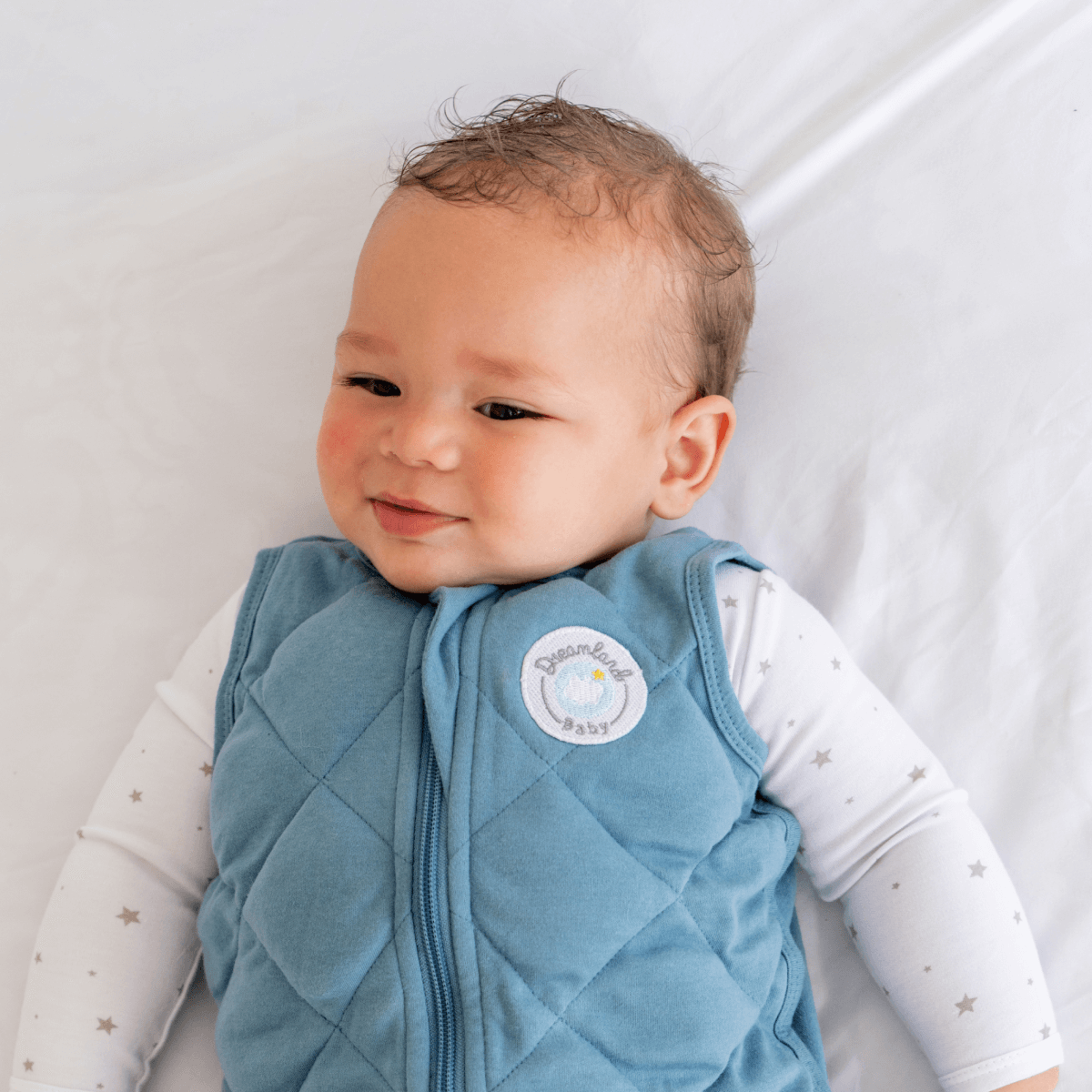 Dreamland Baby Dream Weighted Sleep Sack lying flat, soft fabric, designed for safe sleep and comfort for babies.