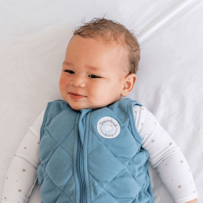 Dreamland Baby Dream Weighted Sleep Sack lying flat, soft fabric, designed for safe sleep and comfort for babies.