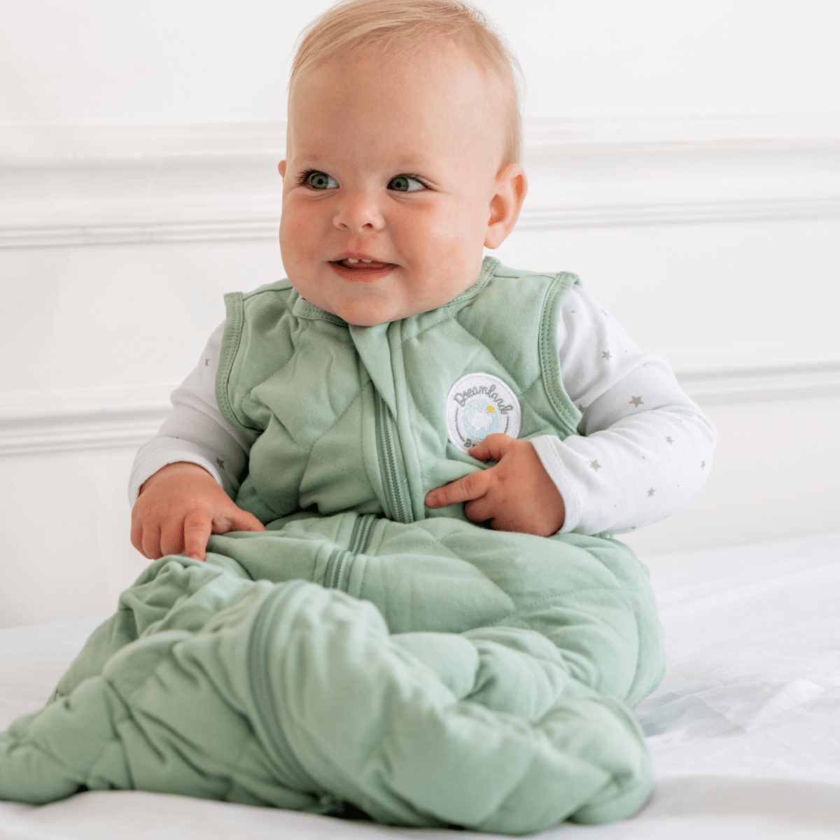 Dreamland Baby Dream Weighted Sleep Sack lying flat, soft fabric, designed for secure, gentle sleep for infants.
