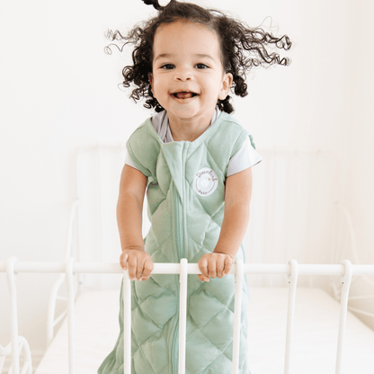 Dreamland Baby weighted sleep sack lying flat, soft fabric, cozy design, designed for safe, comfortable sleep.
