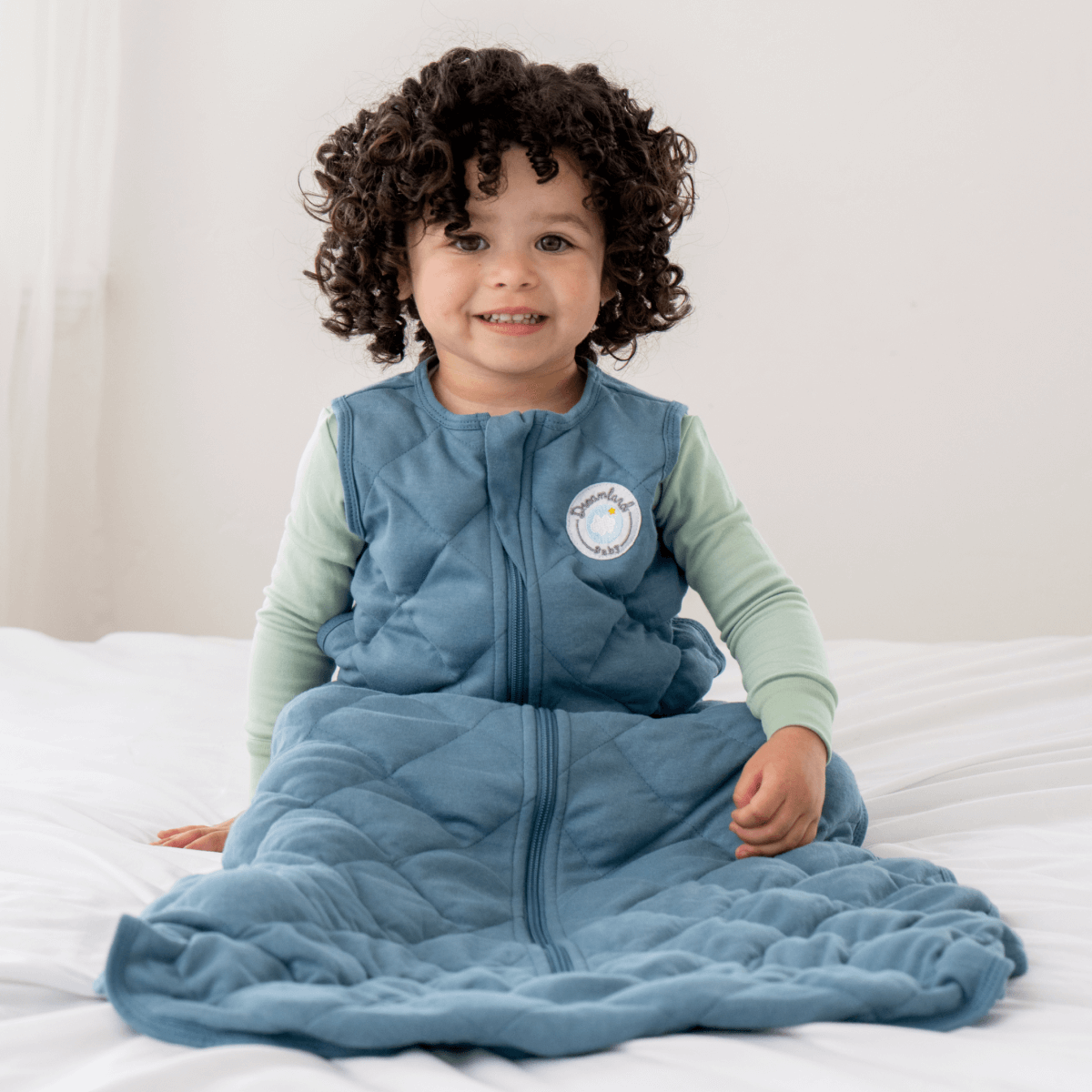 Dreamland Baby weighted sleep sack designed for safe, comfortable sleep, featuring soft fabric and adjustable straps.