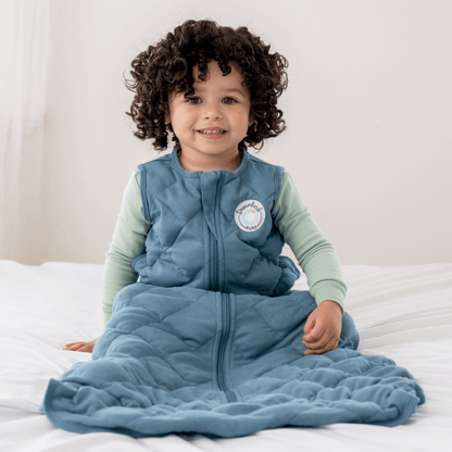 Dreamland Baby weighted sleep sack designed for safe, comfortable sleep, featuring soft fabric and adjustable straps.