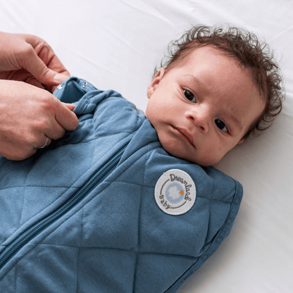Dreamland Baby Dream Weighted Sleep Swaddle, soft fabric, snug fit, designed for calming and secure sleep for infants.