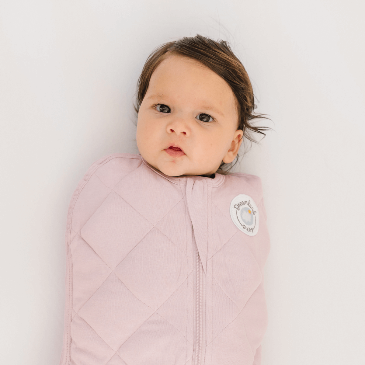 Dreamland Baby Dream Weighted Sleep Swaddle in soft fabric, designed to gently soothe and secure infants for comfortable sleep.