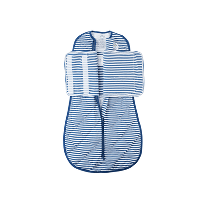 Dreamland Baby Dream Weighted Sleep Swaddle on a bed, showing soft, breathable fabric and secure adjustable fastenings for comfortable sleep.