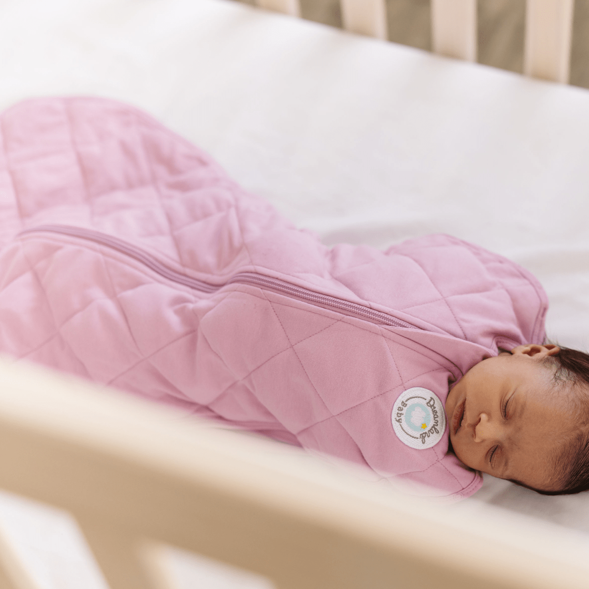 Dreamland Baby Dream Weighted Sleep Swaddle, soft fabric, snug fit, designed to promote better sleep for infants.