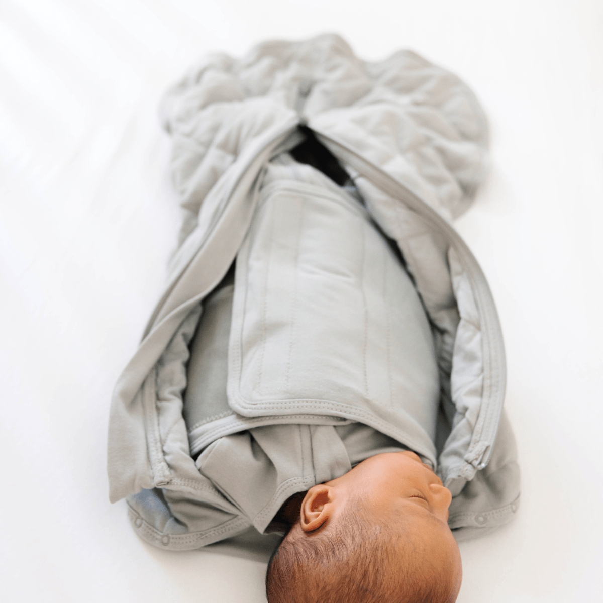 Dreamland Baby Dream Weighted Sleep Swaddle, soft fabric with adjustable wrap for secure, comfortable sleep for infants.