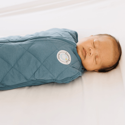 Dreamland Baby weighted sleep swaddle in soft fabric, designed to provide calming comfort for infants during sleep.
