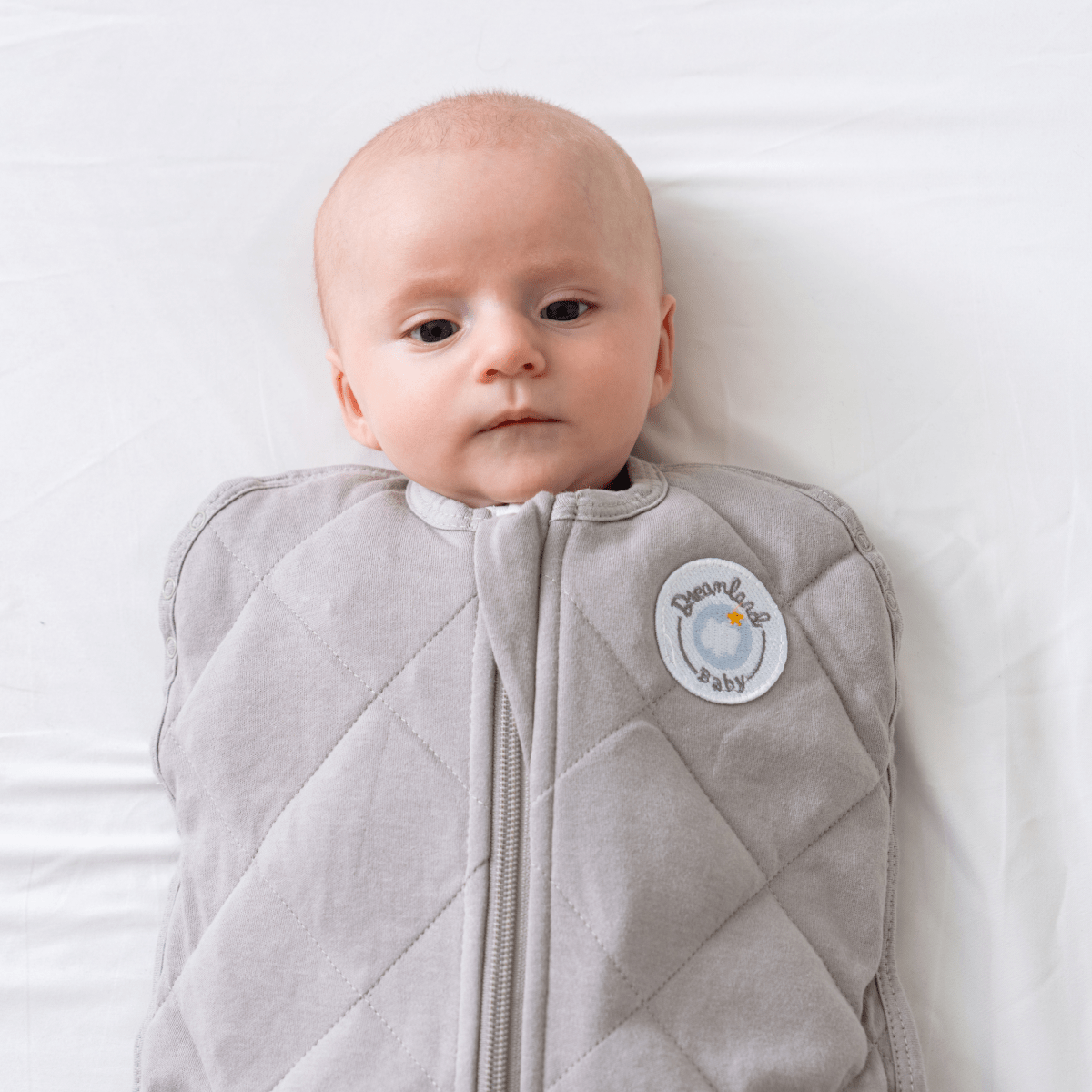 Dreamland Baby Dream Weighted Sleep Swaddle, soft fabric with snug fit, designed to promote better sleep for infants.