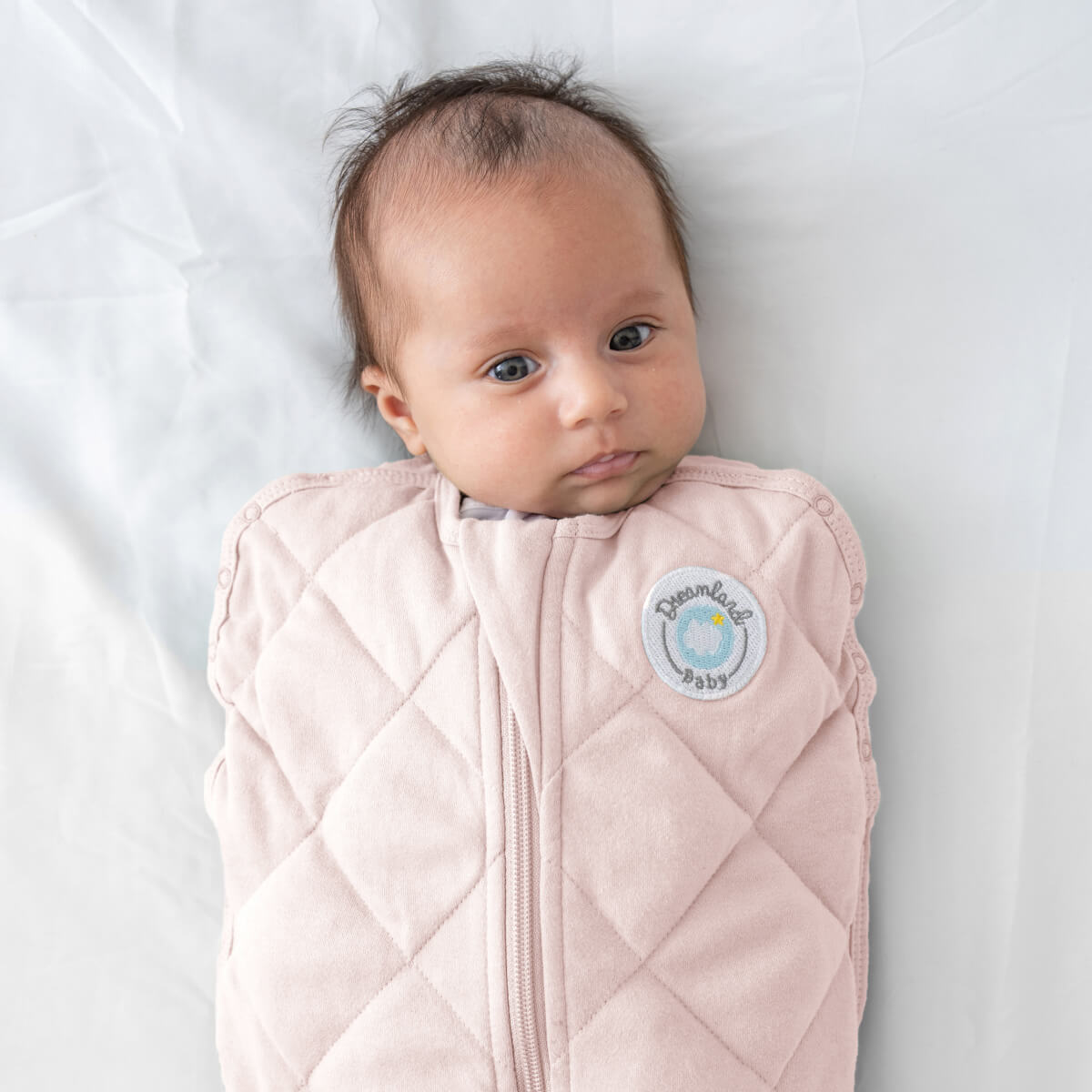 Dreamland Baby Dream Weighted Sleep Swaddle, soft fabric with adjustable straps, designed to promote calm and restful sleep.