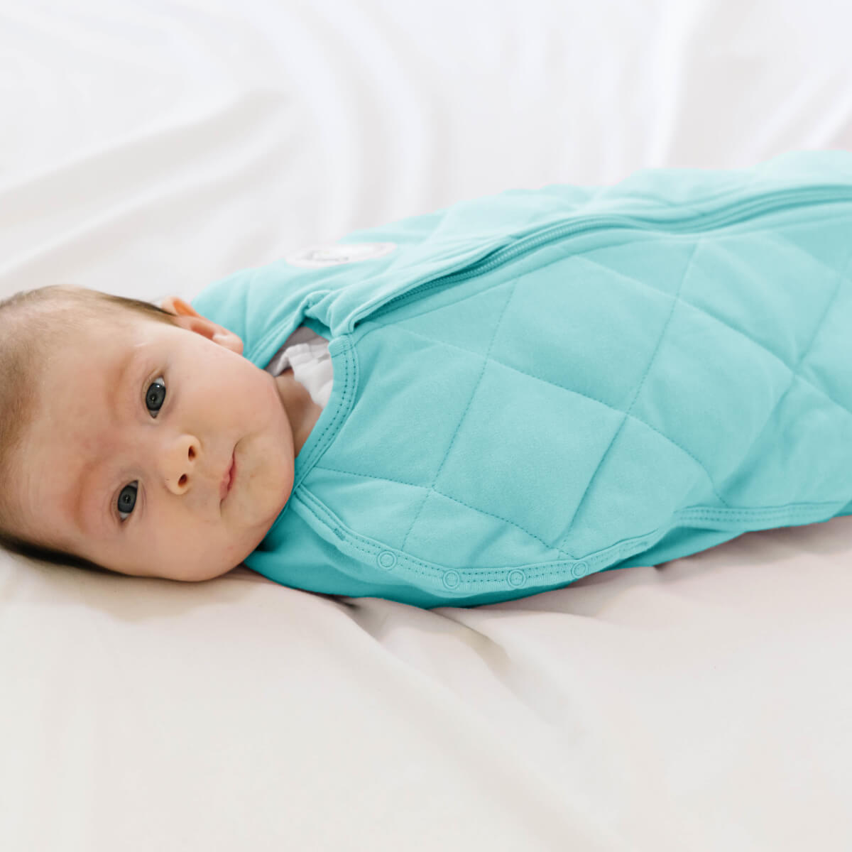 Dreamland Baby Dream Weighted Sleep Swaddle, soft fabric with adjustable fasteners, designed to gently secure and soothe infants during sleep.