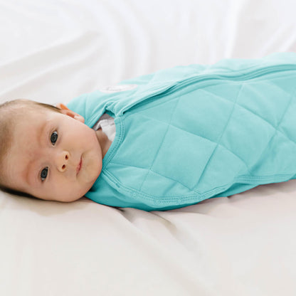Dreamland Baby Dream Weighted Sleep Swaddle, soft fabric with adjustable fasteners, designed to gently secure and soothe infants during sleep.