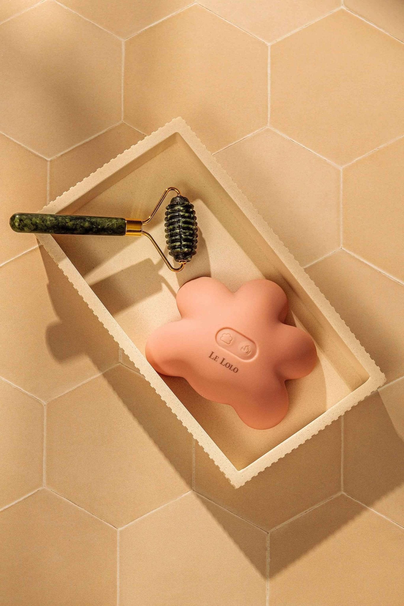 Le Lolo Lactation Jade Roller for breast massage and relief, featuring smooth jade stones on a sleek handle.