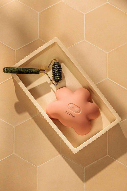 Le Lolo Lactation Jade Roller for breast massage and relief, featuring smooth jade stones on a sleek handle.