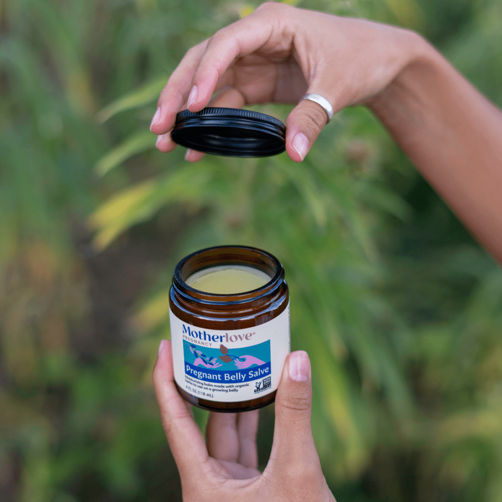 Pregnant belly salve from Motherlove Herbal Company, showing a jar of pregnancy skin moisturizer for stretch marks and skin comfort.