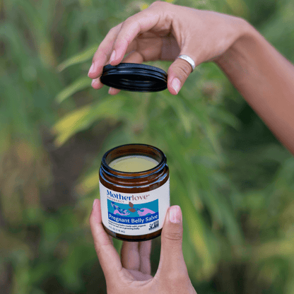 Pregnant belly salve from Motherlove Herbal Company, showing a jar of pregnancy skin moisturizer for stretch marks and skin comfort.