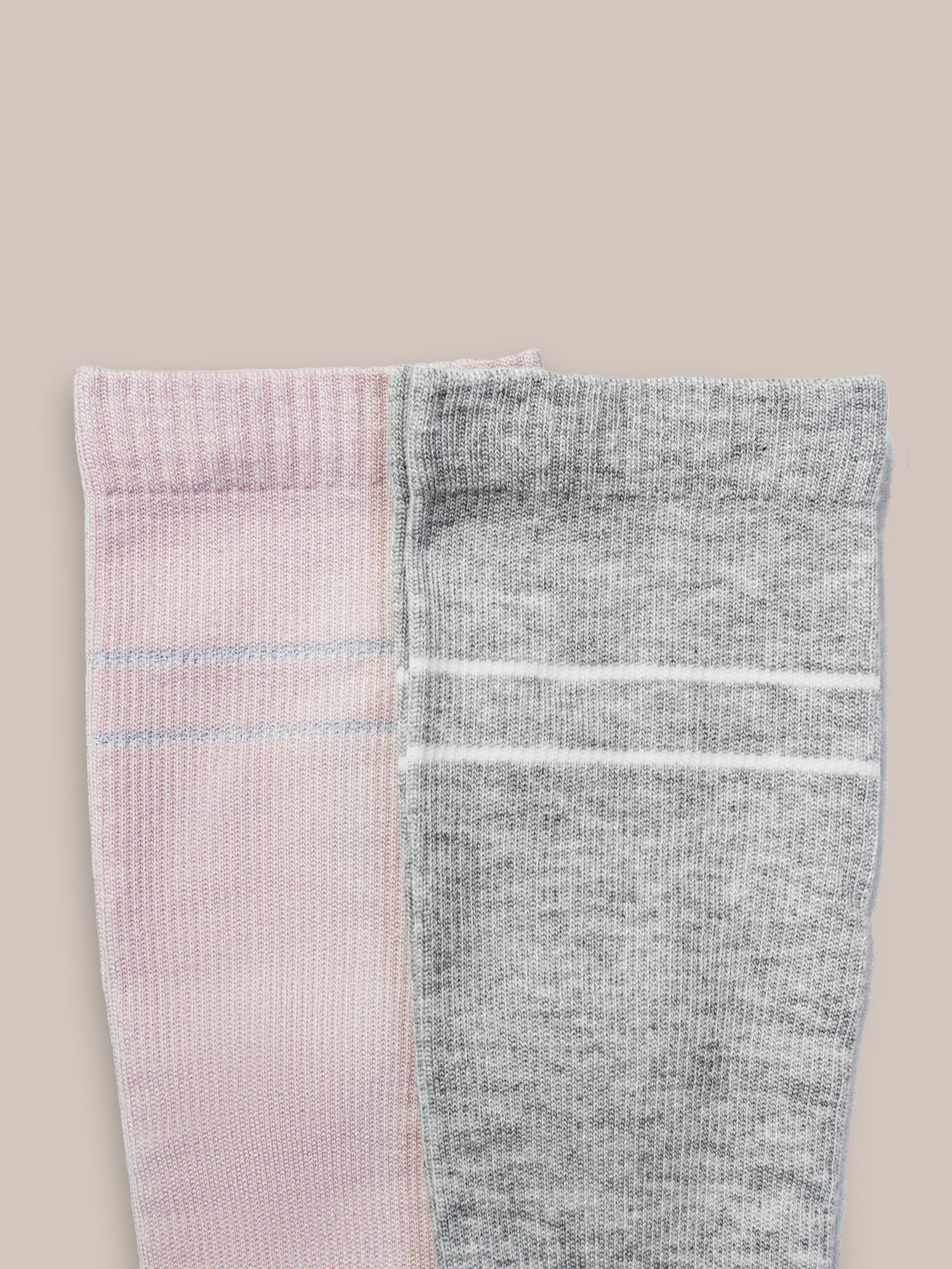 Pair of Kindred Bravely maternity compression socks in soft pink and grey heather, designed for comfort and support during pregnancy.