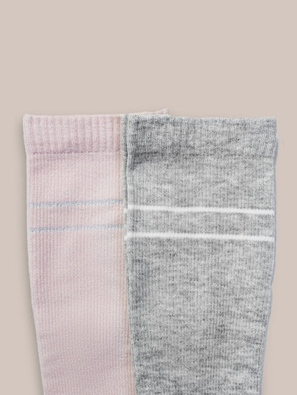 Pair of Kindred Bravely maternity compression socks in soft pink and grey heather, designed for comfort and support during pregnancy.