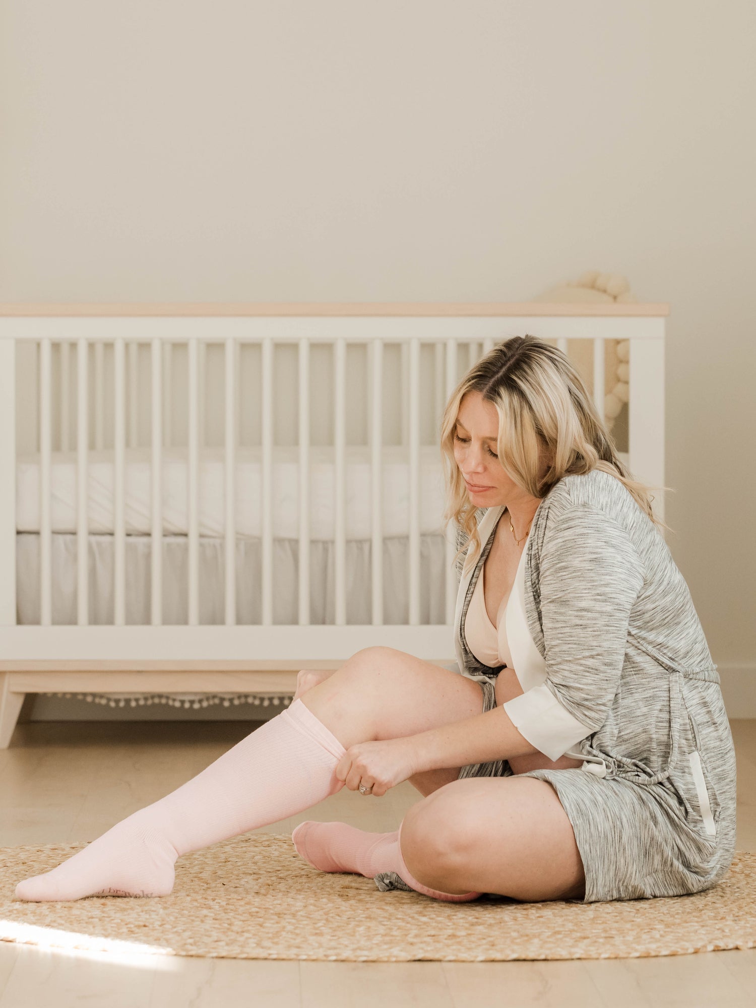 Pair of Kindred Bravely premium maternity compression socks in soft pink and grey Heather, designed for comfort and support.
