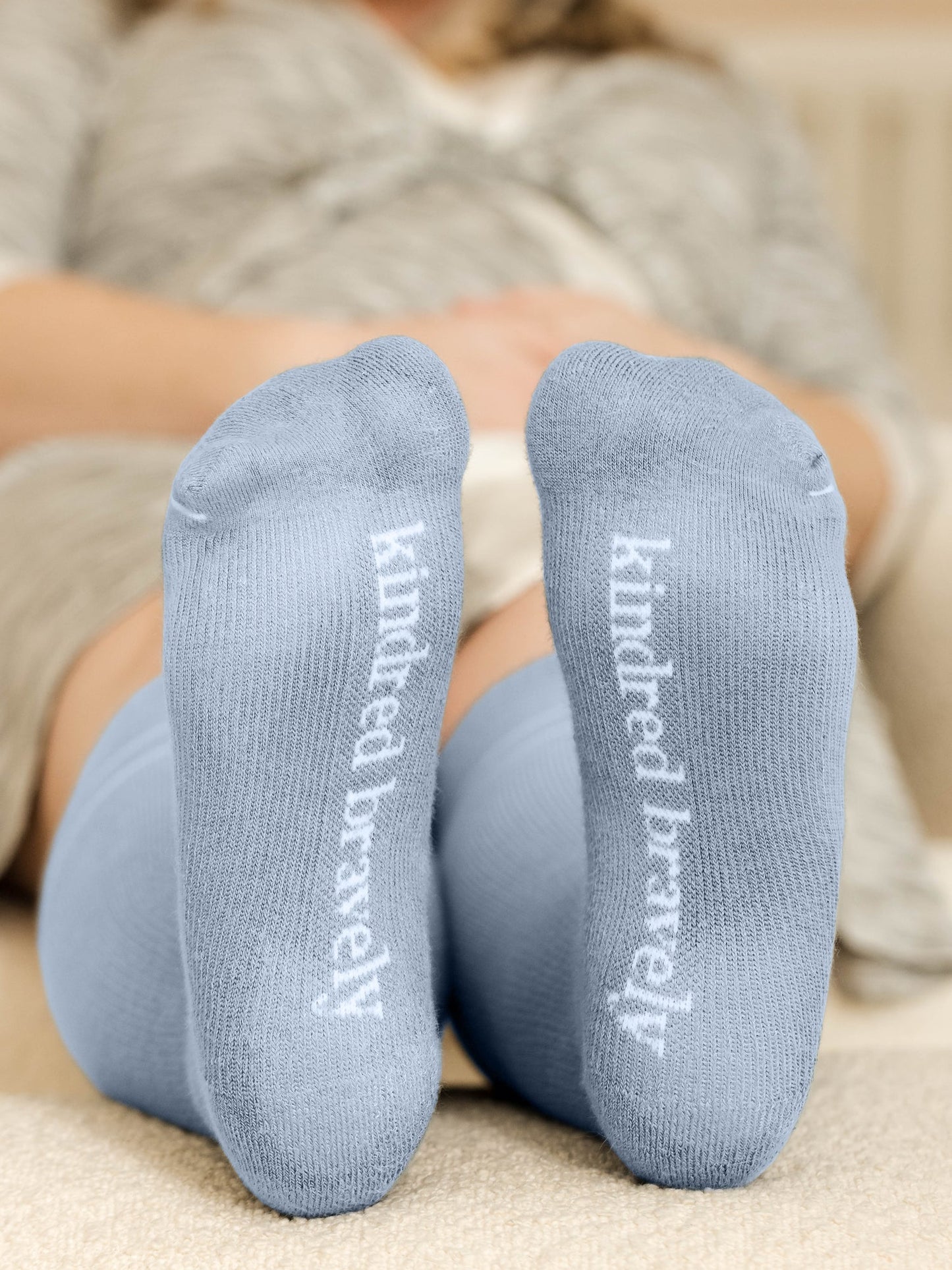 Pair of Kindred Bravely maternity compression socks in stone blue and black, designed for comfort and support during pregnancy.