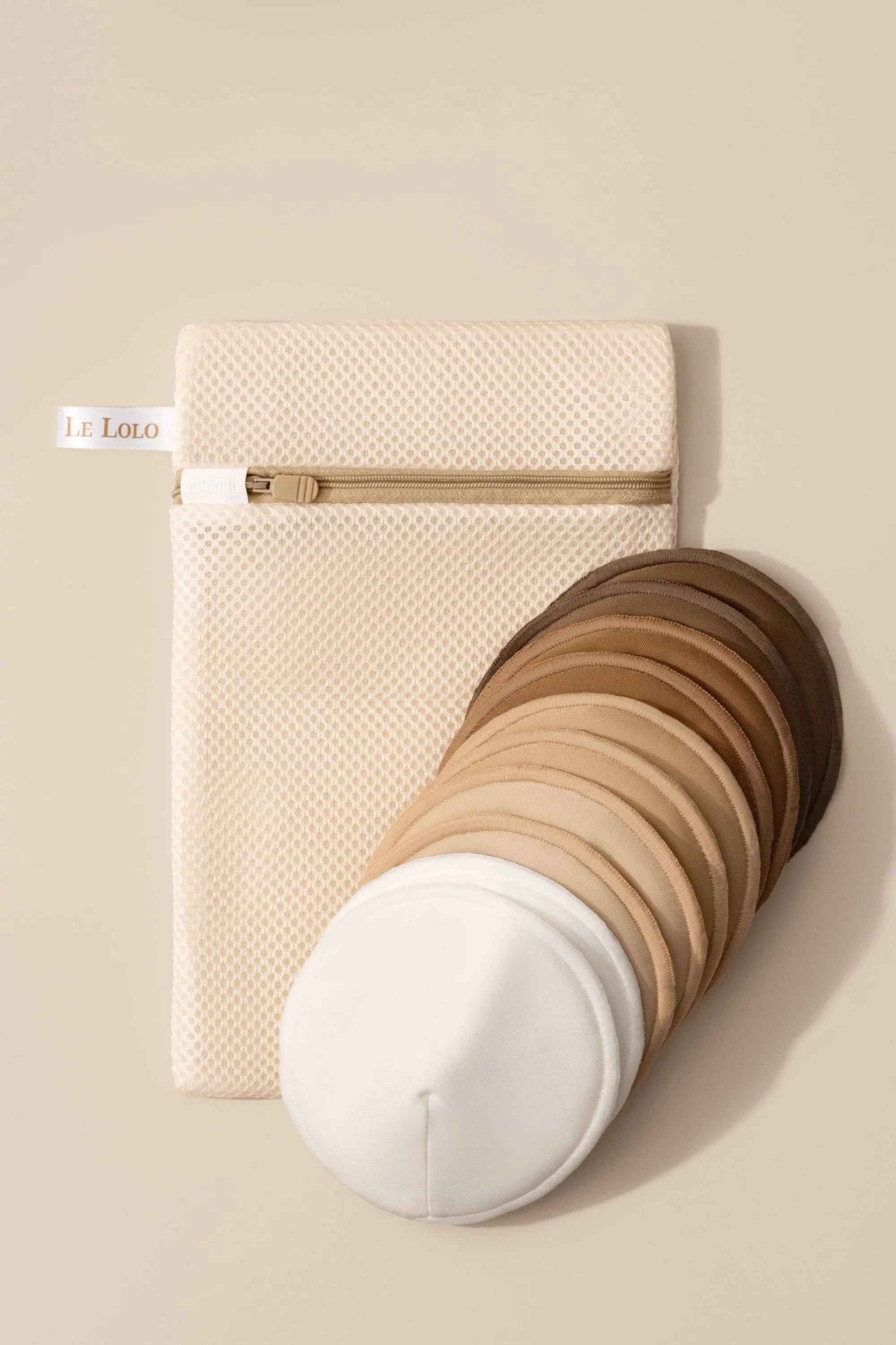 Le Lolo reusable nursing pads shown in a set, soft fabric with absorbent layers, designed for comfortable breastfeeding support.