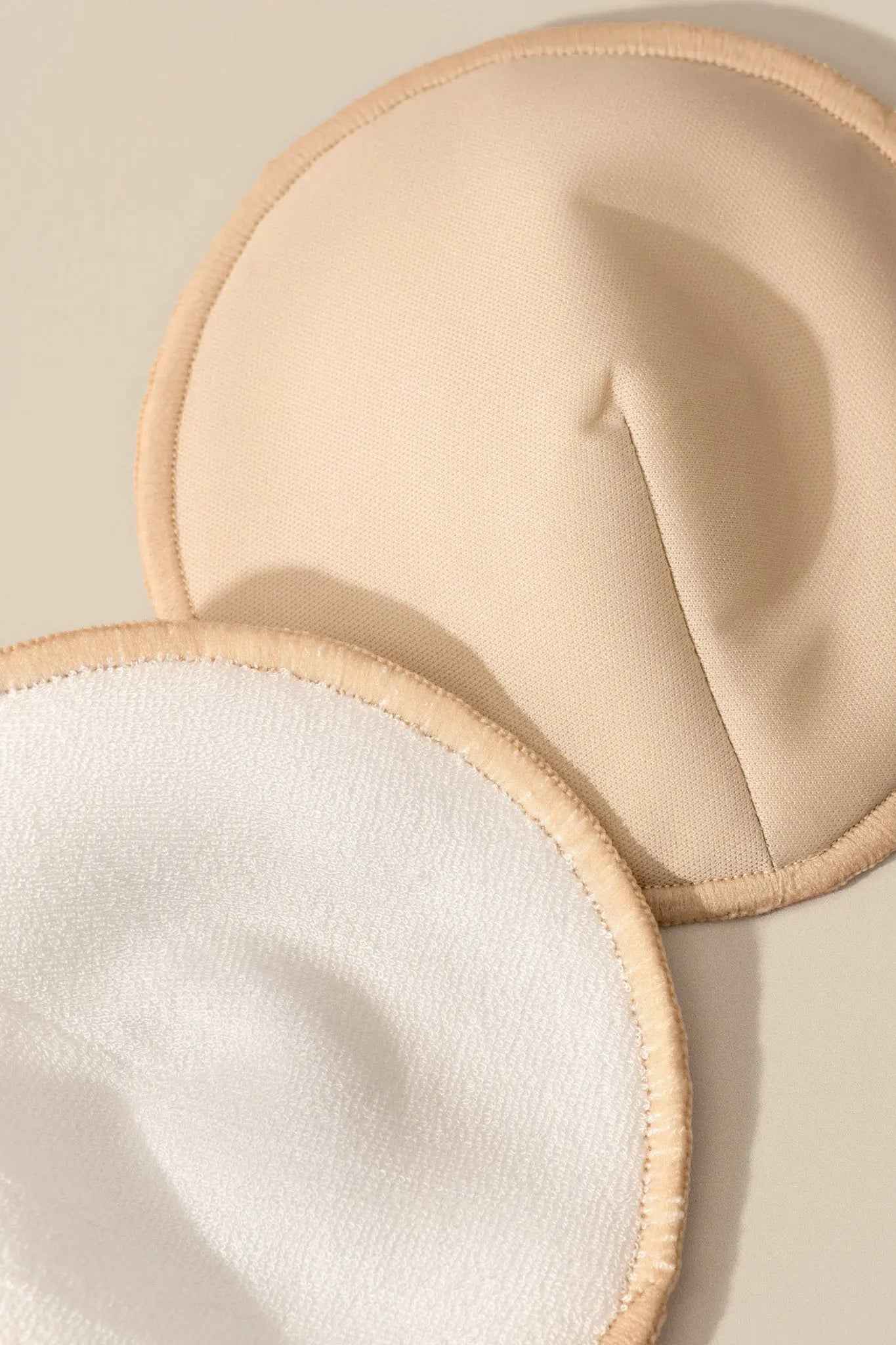 Set of reusable nursing pads by Le Lolo, soft and absorbent fabric for comfortable breastfeeding support.