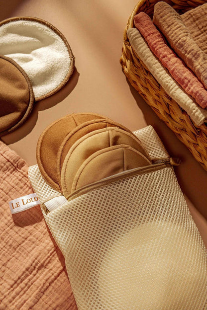 Le Lolo reusable nursing pads displayed flat, showing soft, absorbent fabric for breastfeeding comfort and leak protection.