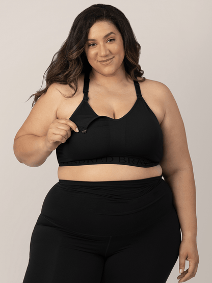 Black Sublime® hands-free pumping and nursing sports bra by Kindred Bravely, shown on a model with adjustable straps and supportive design.