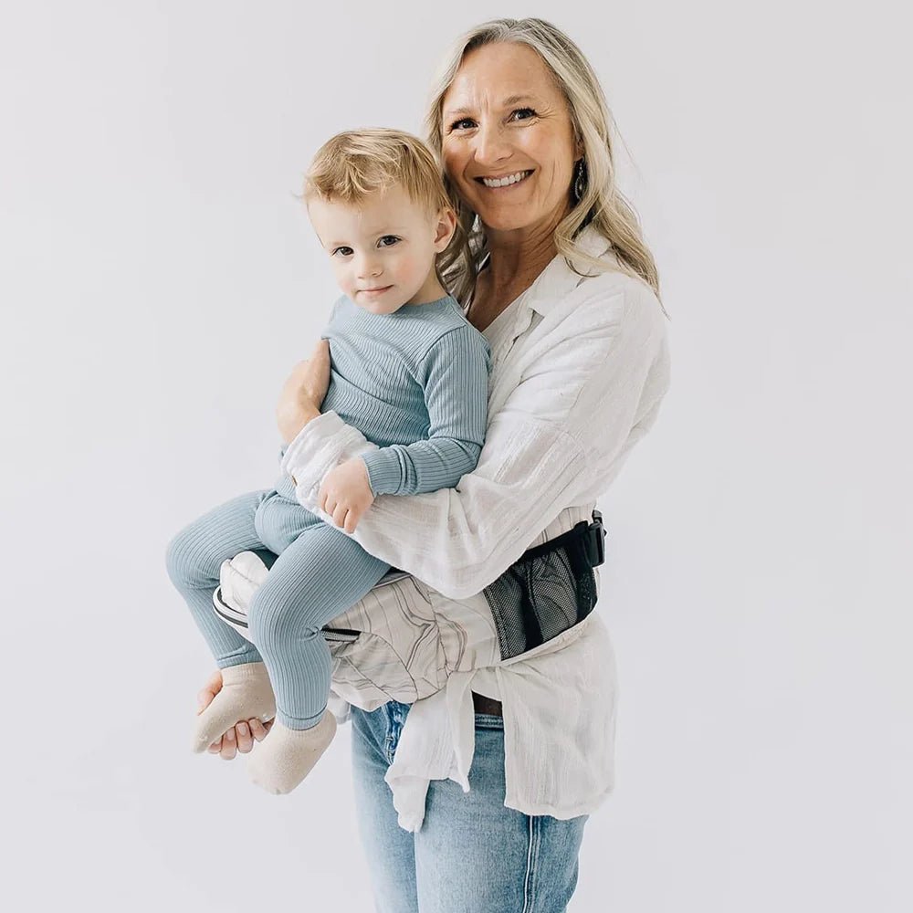 Tushbaby Hip Carrier for babies and toddlers, featuring adjustable straps and padded support, designed for comfortable carrying.