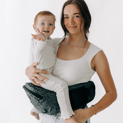 Tushbaby Hip Carrier for babies and toddlers, adjustable ergonomic design with padded support and secure straps.
