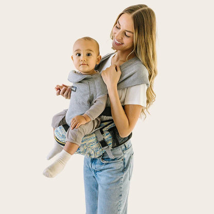 Tushbaby Hip Carrier for babies and toddlers, featuring adjustable straps and ergonomic design for comfortable carrying.