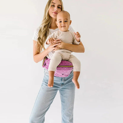Tushbaby Hip Carrier for babies and toddlers, adjustable ergonomic design with padded straps, supporting comfortable carrying.