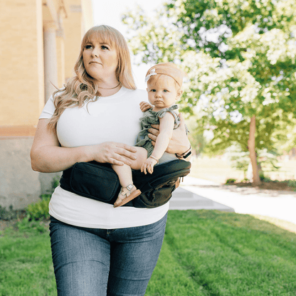 Tushbaby Hip Carrier for babies and toddlers, featuring adjustable straps and ergonomic design for comfortable carrying.