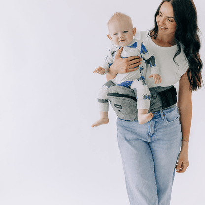 Tushbaby Hip Carrier for babies and toddlers, showing a comfortable, ergonomic design with padded straps and waist support.
