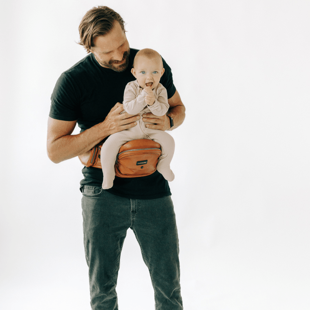 Tushbaby Hip Carrier for babies and toddlers, featuring padded straps and supportive design for comfortable carrying.