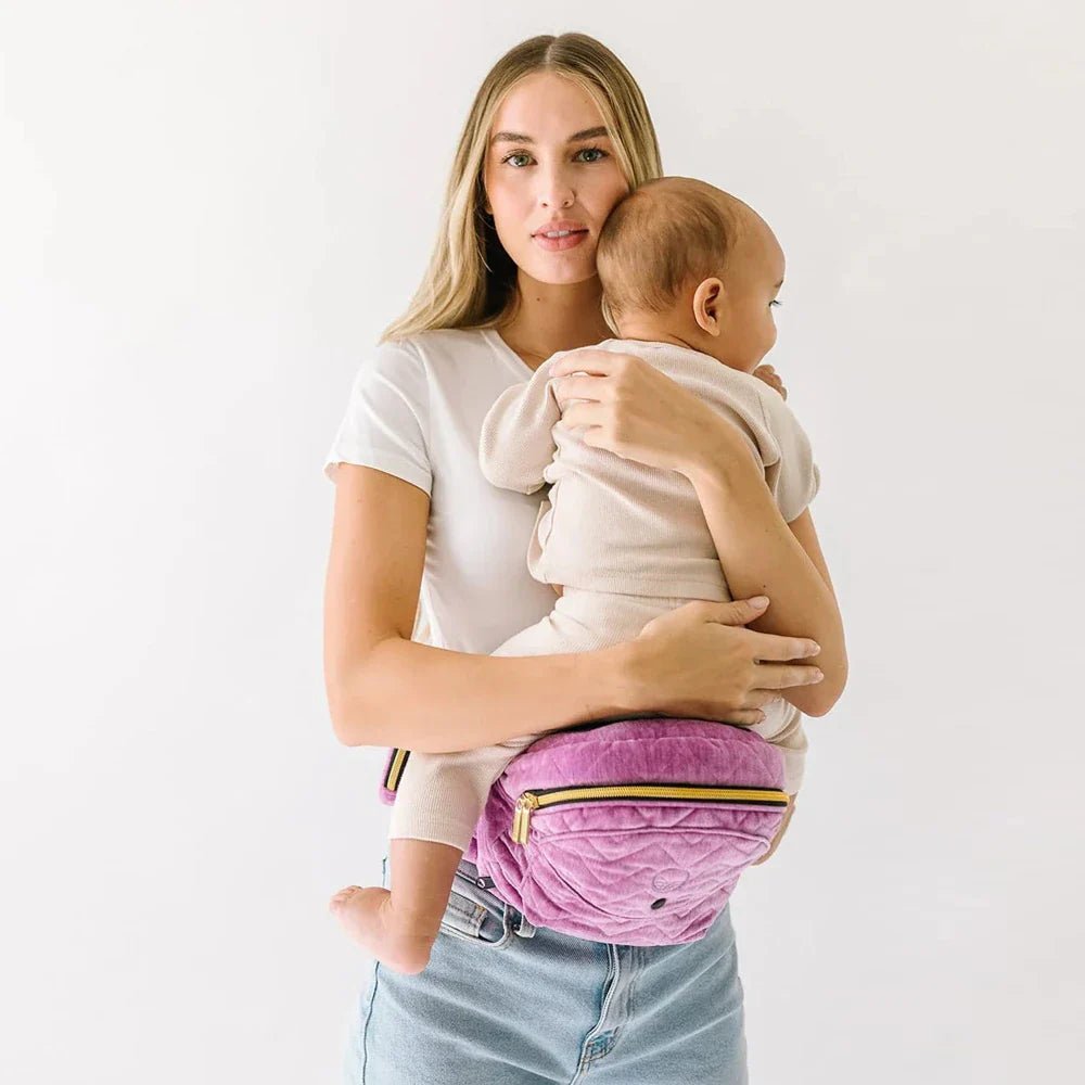 Baby and toddler hip carrier by Tushbaby, showing ergonomic design and adjustable straps for comfortable carrying.