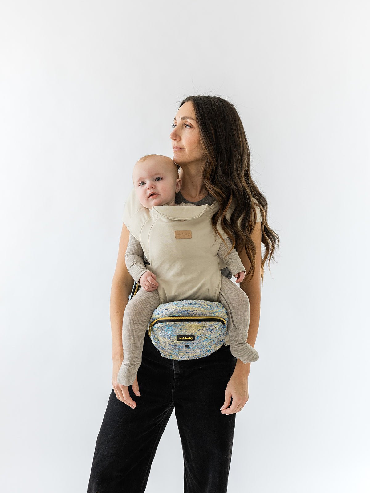 Baby wearing the Tushbaby Hip Carrier for toddlers, showing adjustable straps and comfortable support for parents and children.