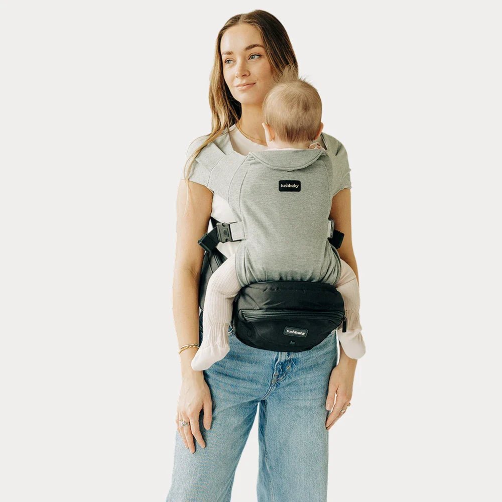 Tushbaby Hip Carrier for babies and toddlers, featuring adjustable straps and ergonomic design, shown in a close-up image.