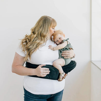 Tushbaby Hip Carrier for babies and toddlers, featuring adjustable straps and padded support for comfortable carrying.