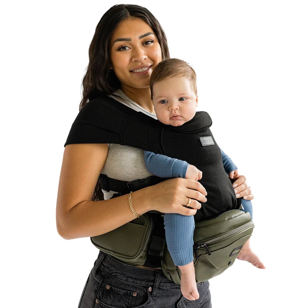 Tushbaby Hip Carrier for babies and toddlers, black fabric, adjustable straps, ergonomic design for comfortable carrying.